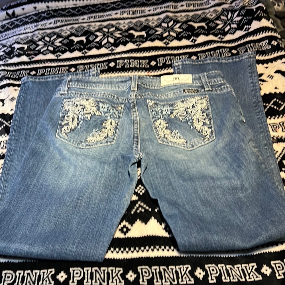 Low-rise  blue jeans gently worn. No signs of wear.
